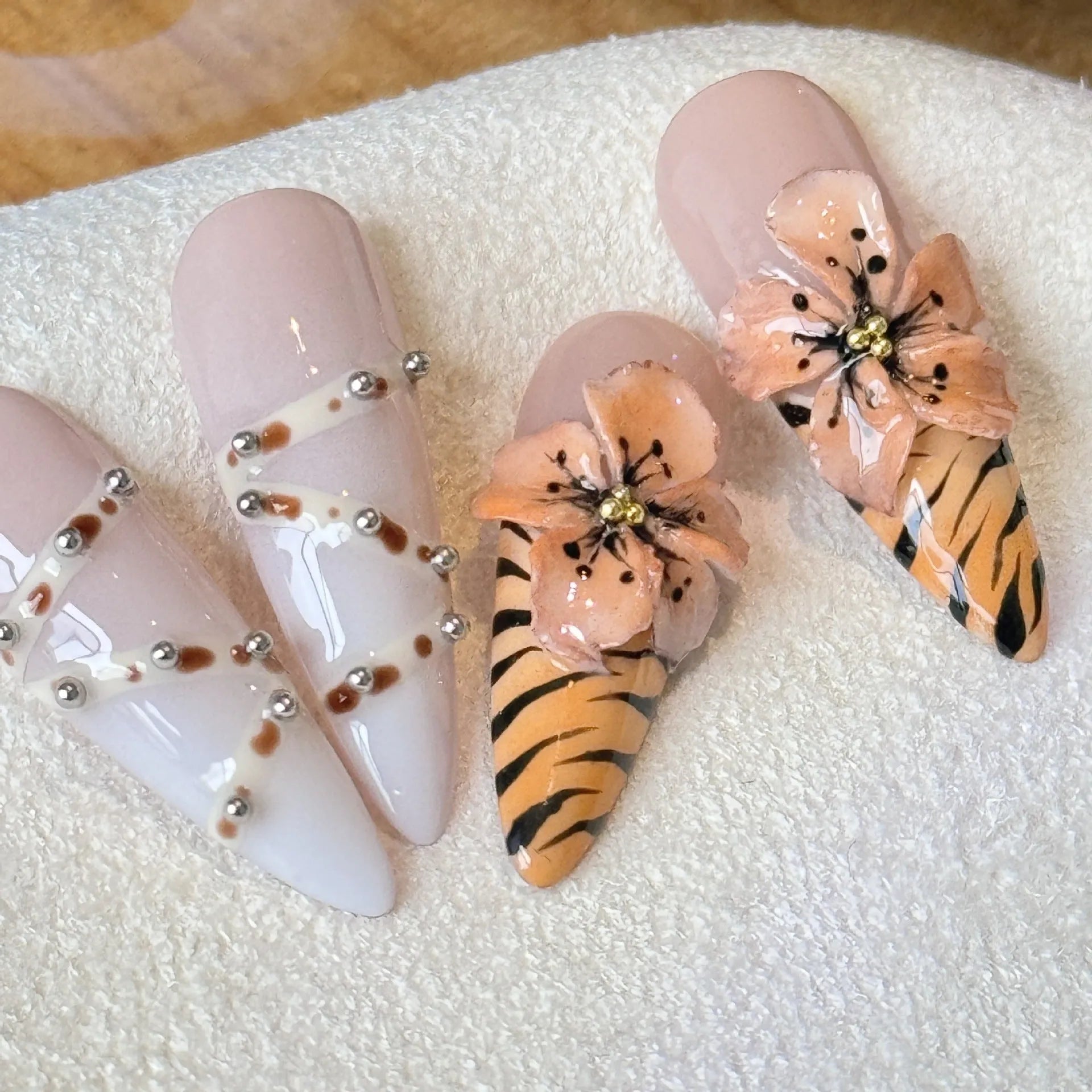 Handmade leopard print false eyelashes with cross and flower details on nail stickers.