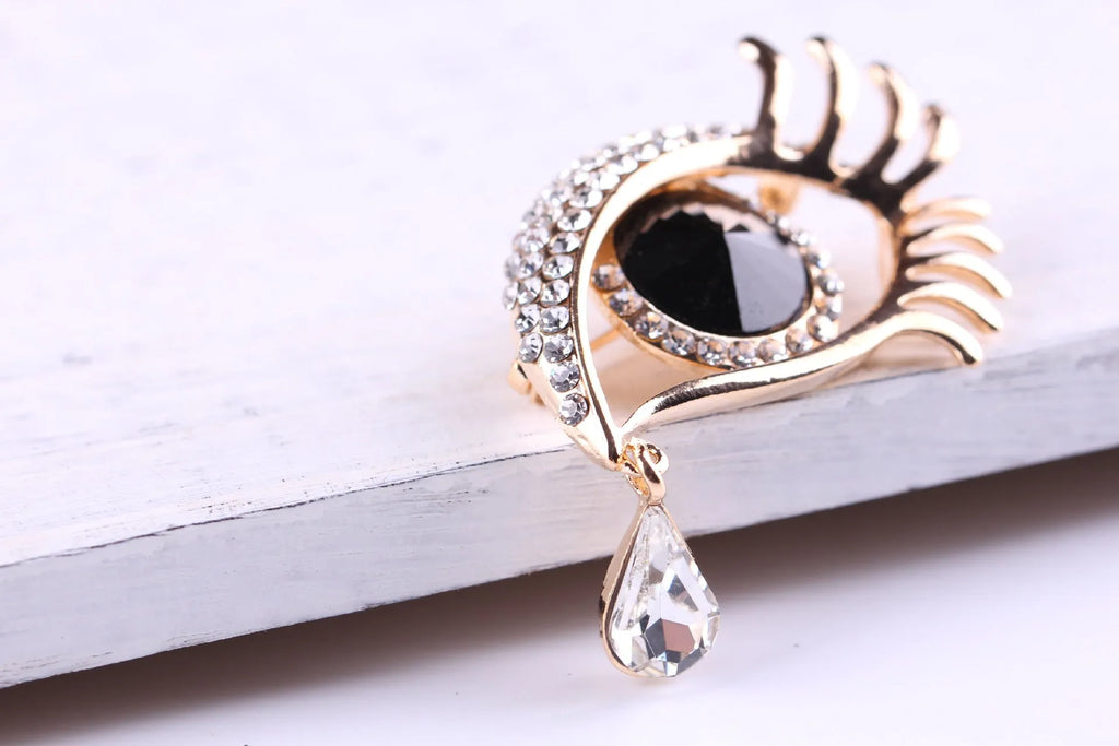 Teardrop rhinestone brooch pin alloy gold electroplated unisex totem style