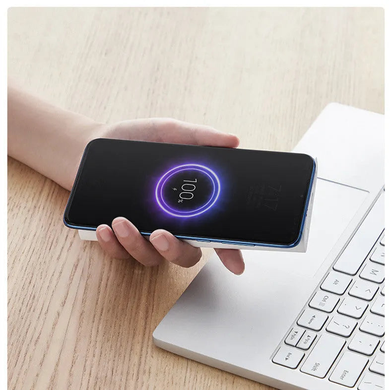White and Black coloured 10000mAh portable power bank with wireless charging pad and USB ports.