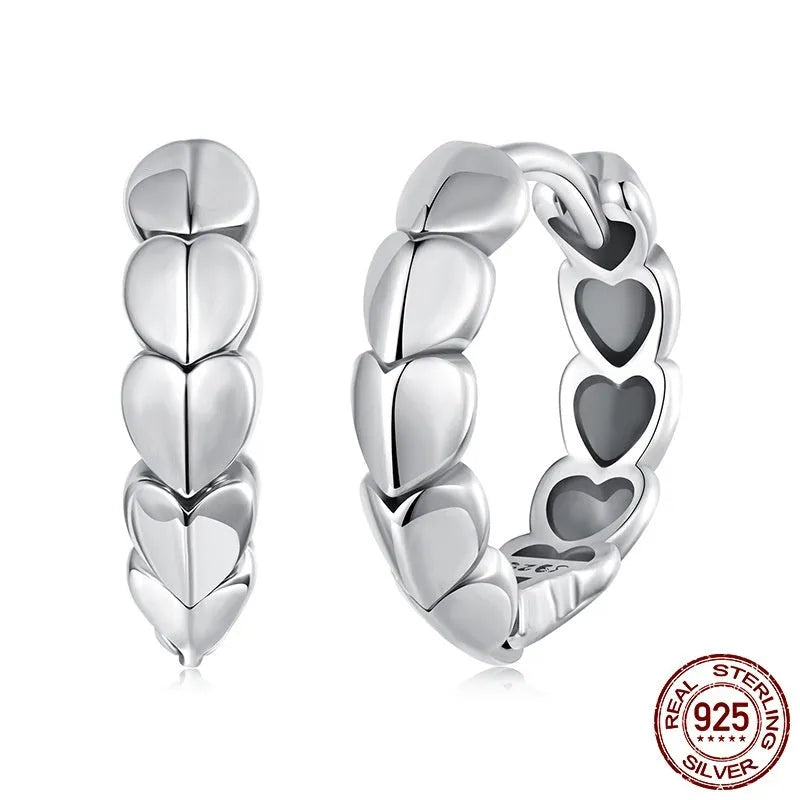 S925 sterling silver loving heart splicing ear clip with polished finish on white background