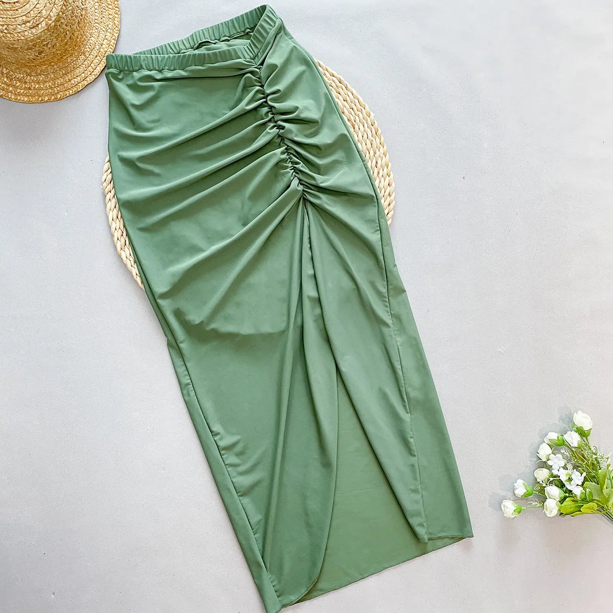 Women's brown one-piece swimsuit with a matching detachable beige skirt laid flat.