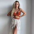 White backless push-up bikini top with high-waisted panties and matching skirt, three-piece set on mannequin.