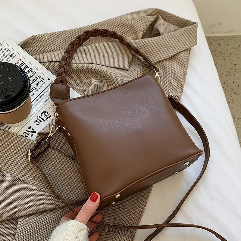 Retro brown PU bucket bag with weaving detail, shown as a one-shoulder crossbody underarm bag.