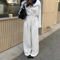White striped wide-leg casual trousers with zipper detailing on a mannequin.