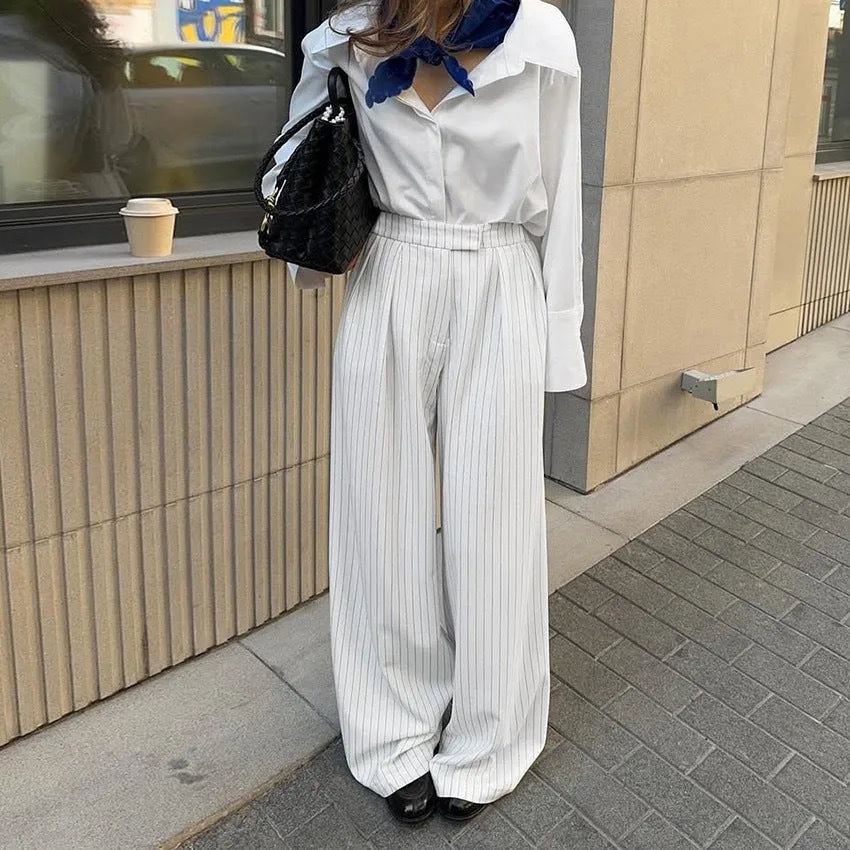 White striped wide-leg casual trousers with zipper detailing on a mannequin.