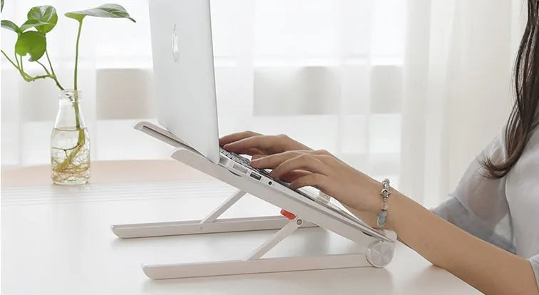 White portable laptop bracket with heat sink base in folded position.