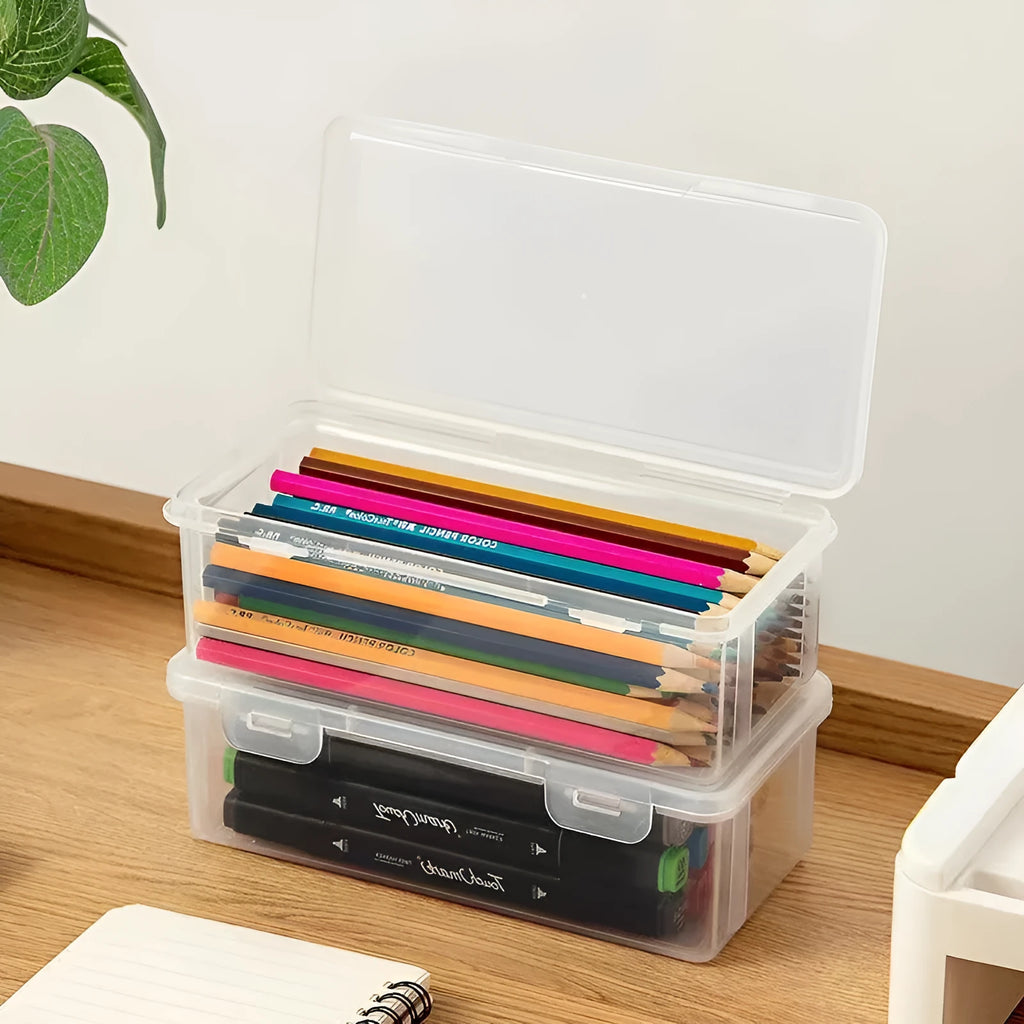 Large transparent plastic stationery storage box filled with coloured pencils and pens