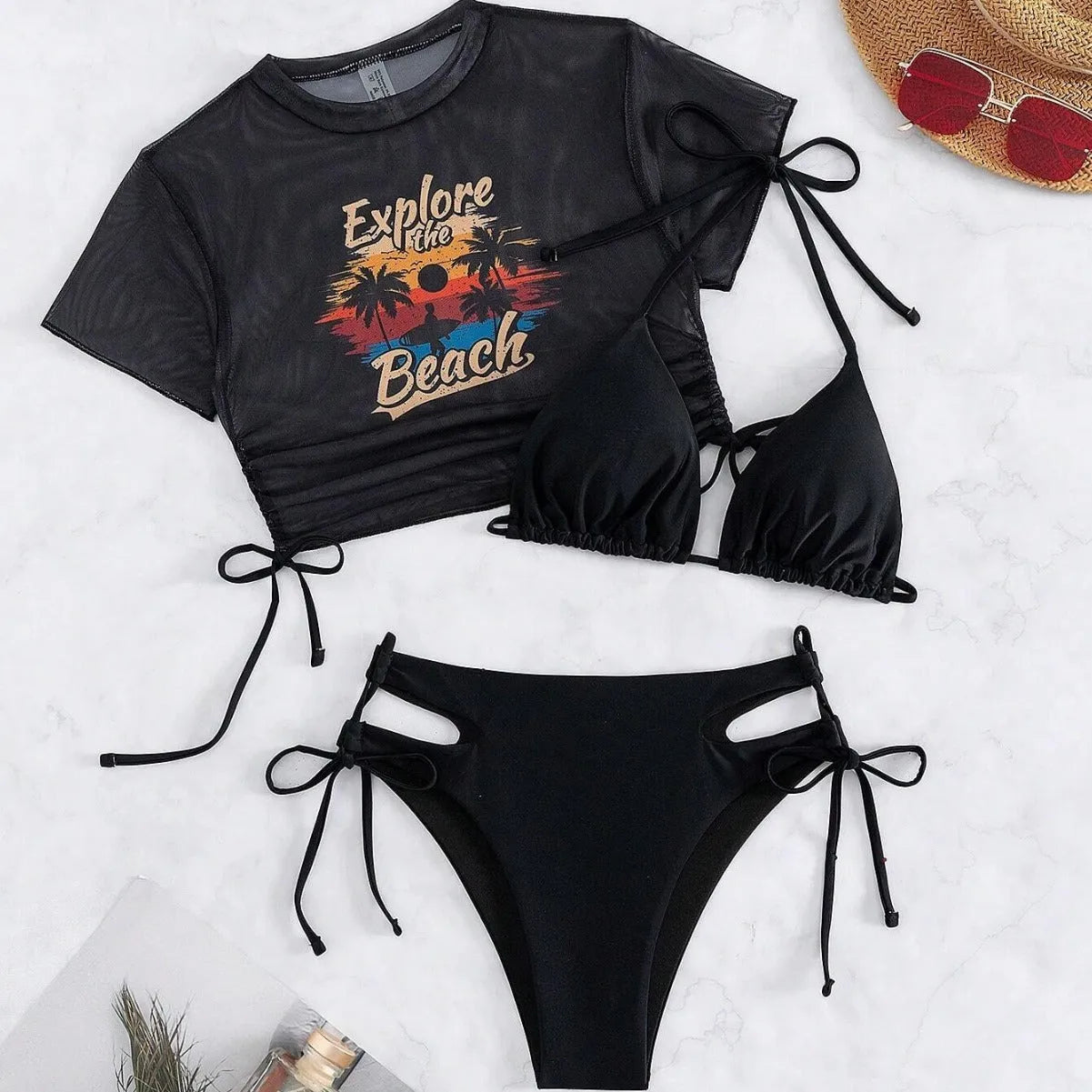 Women's three-piece bikini swimsuit set in black, shown with short sleeves and matching pants.