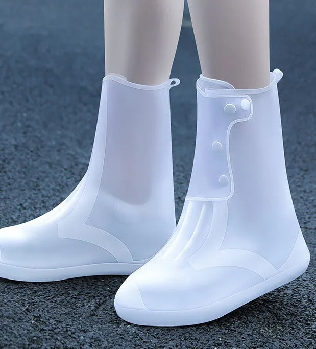 Women's white PVC high top reusable waterproof shoe covers shown on feet