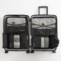 Seven-piece waterproof travel tote bag set in black and gray with six sorting bags and cation hardware