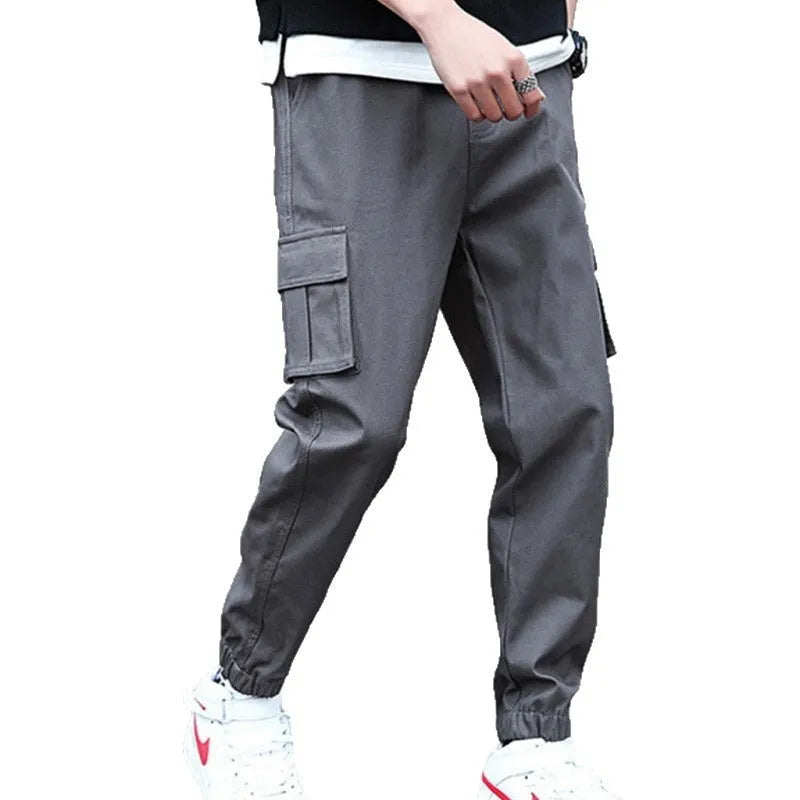 Khaki multi-pocket harem trousers with tapered mid-waist and elastic waistband, polyester fabric