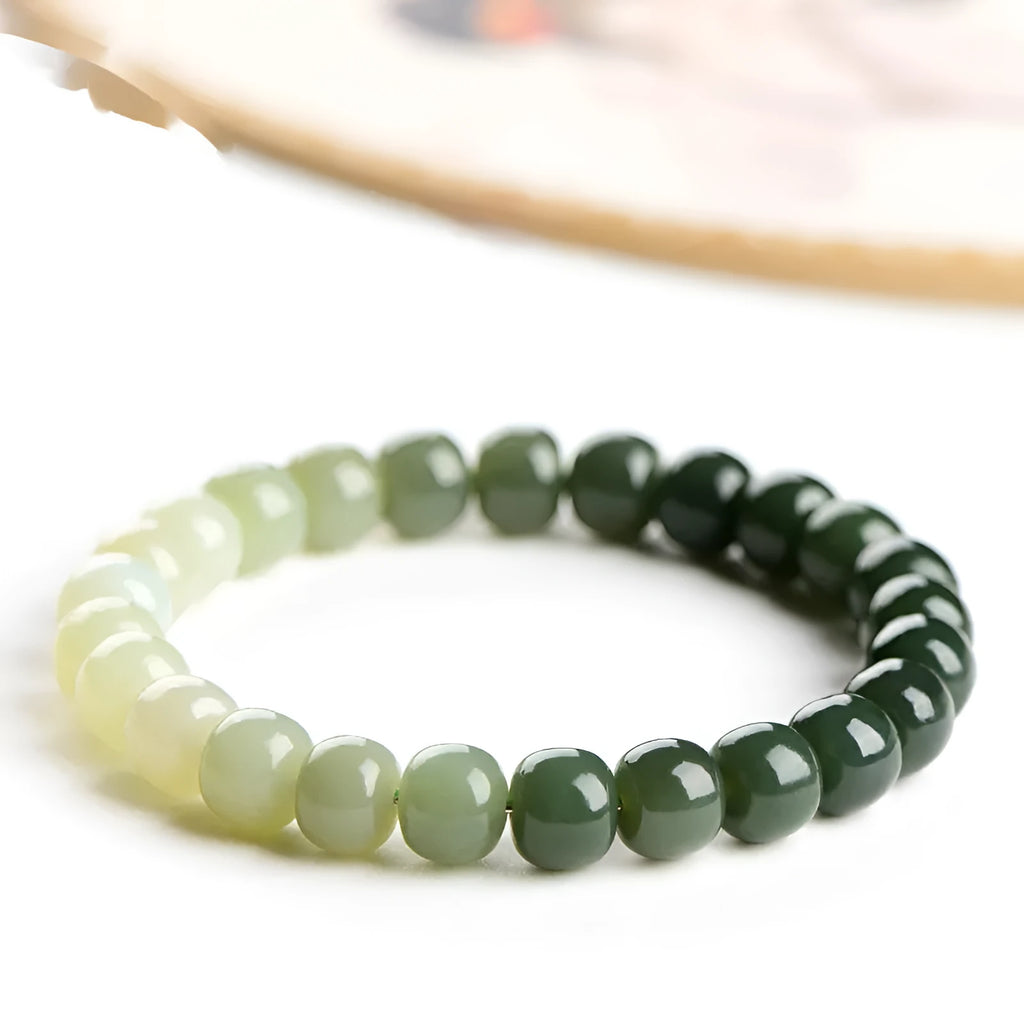 Polished Hetian jade bracelet with gradient clear water colour and round beads.