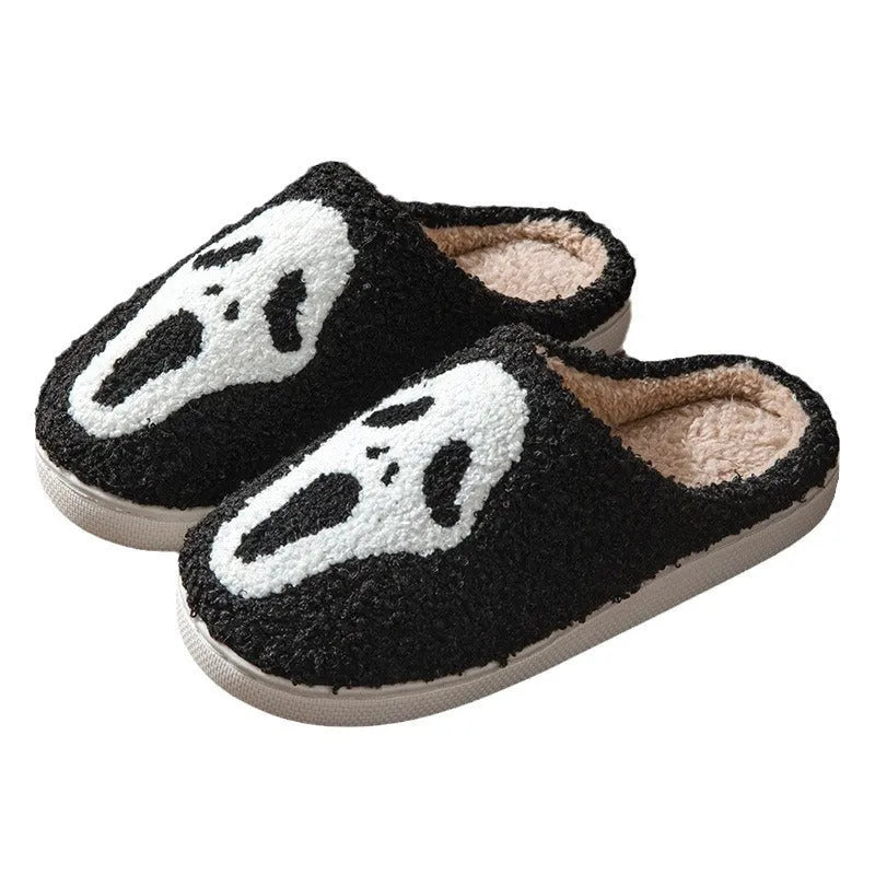 Halloween couple slippers with black and orange ghost face embroidery on suede upper and PVC sole.