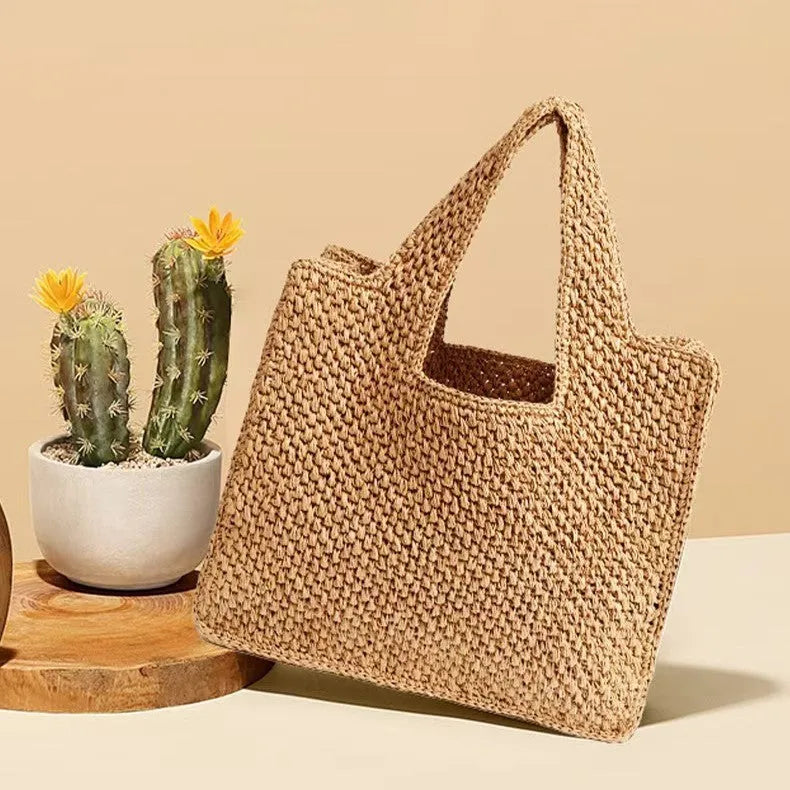 Khaki woven straw bucket tote bag with double straps, open pocket, and horizontal square shape