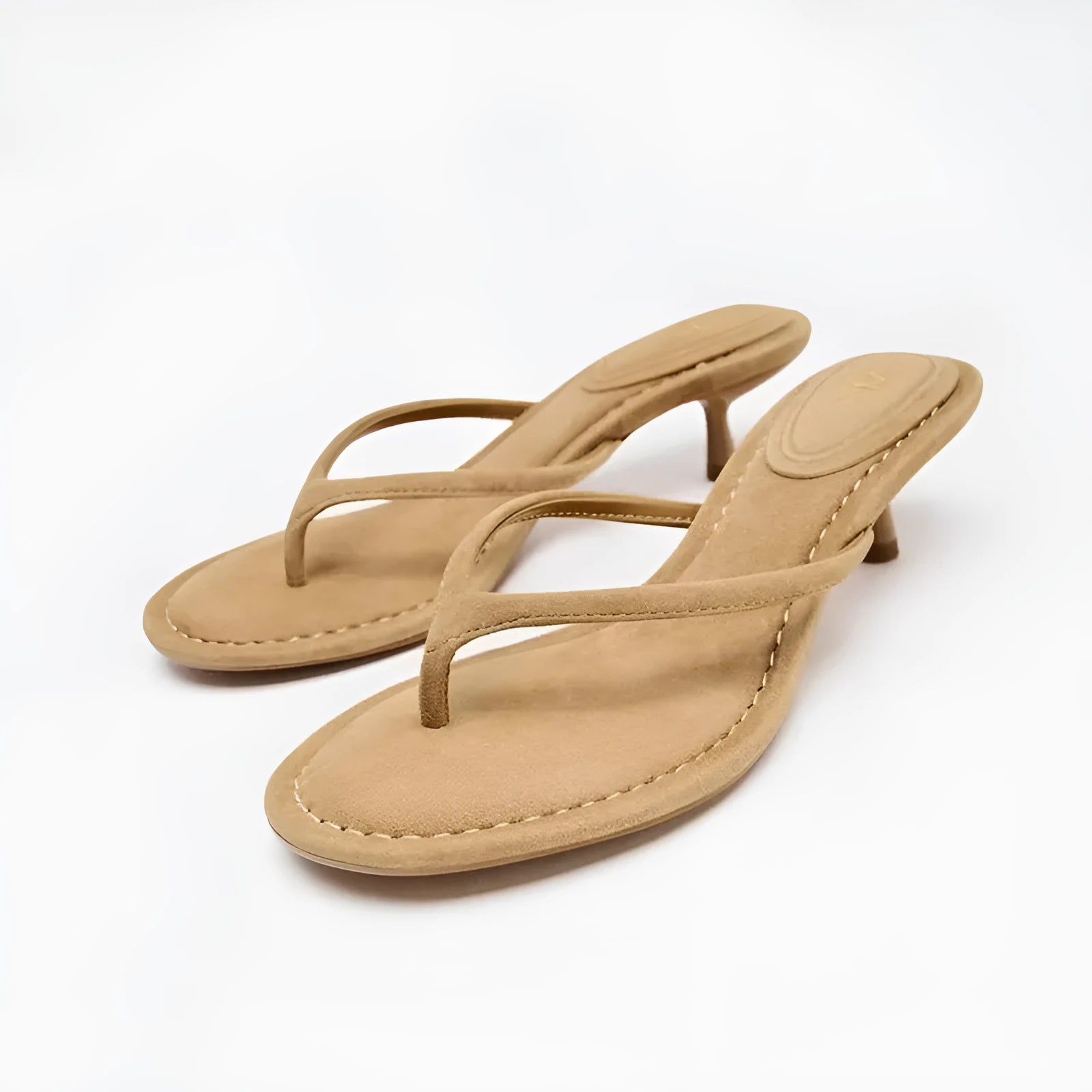 Black women's mid-heel sandals with a round toe and flip-toe strap on a white background