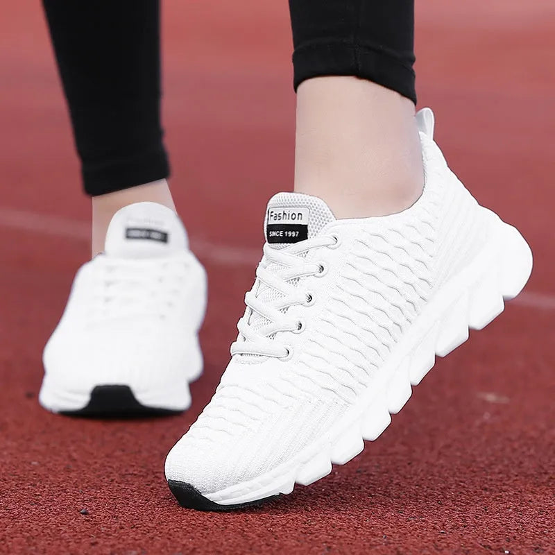 Women's running shoes in black, pink, or white with fly weave upper and wear-resistant sole