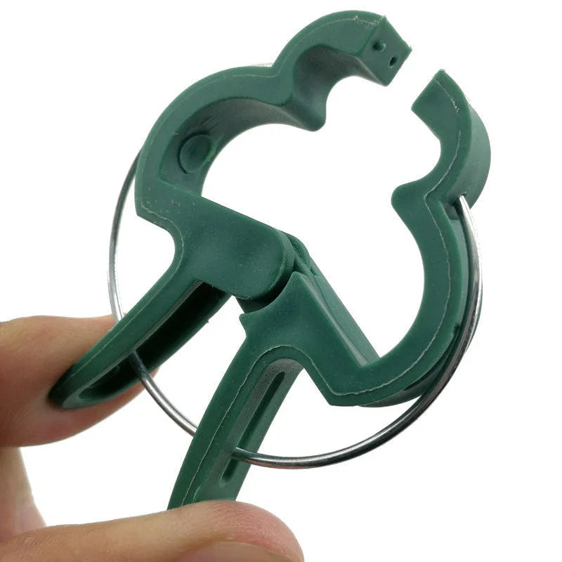 Green plastic and zinc plant fixing clips in large and small sizes for supporting climbing plants in the garden.