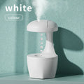 White portable 800ml anti gravity USB cool mist aromatherapy humidifier on a bedside table with water droplet effect visible