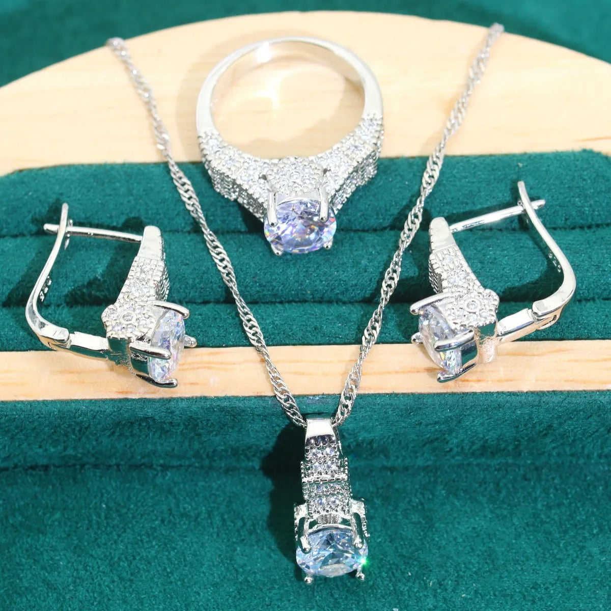 Four-piece bridal jewellery set showing zircon necklace, bracelet, earrings, and ring in coordinating design