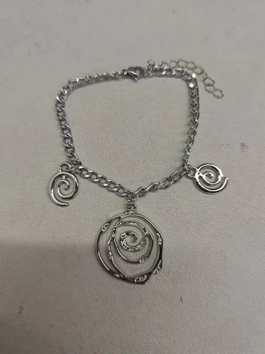 Gold tone spiral donut necklace, bracelet, and earrings set on a white background