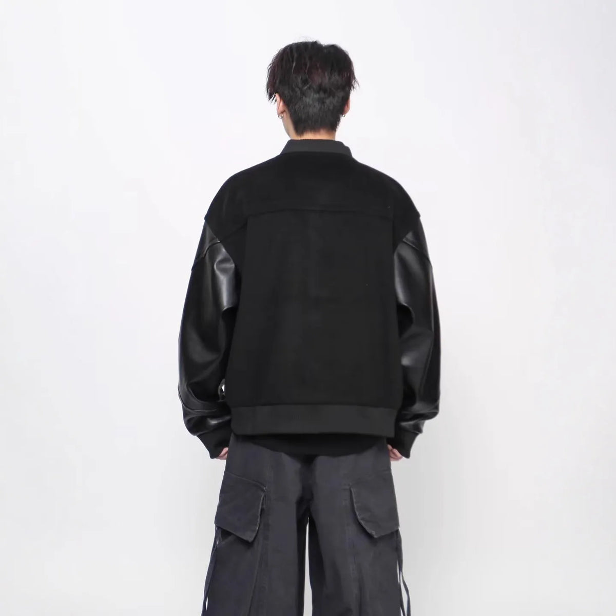 Black loose faux leather coat with longfengni patchwork, polyester lining and side seam pockets