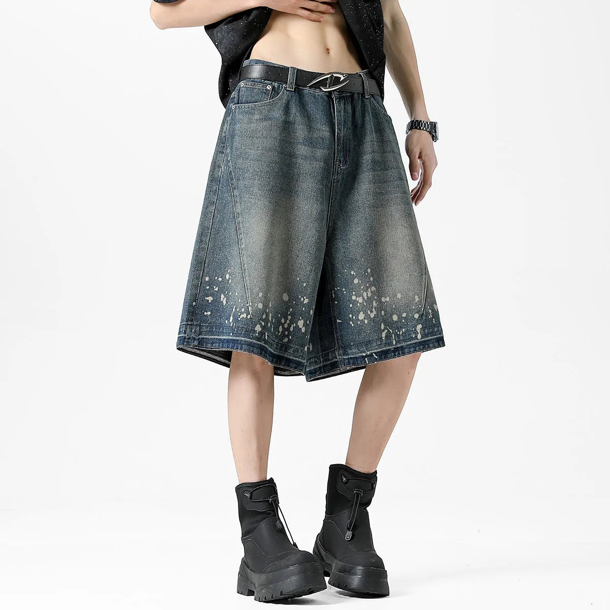 Retro blue washed denim shorts for men with a splash ink pattern and ripped detailing on the legs.