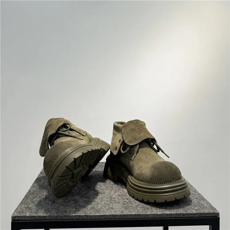 Men's brown distressed cow suede worker boots with thick sole and sewing detail.