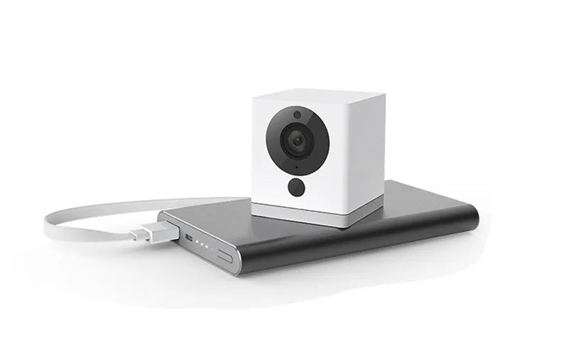 White compact indoor night vision security camera with 1080P resolution and 110° wide-angle lens on a shelf