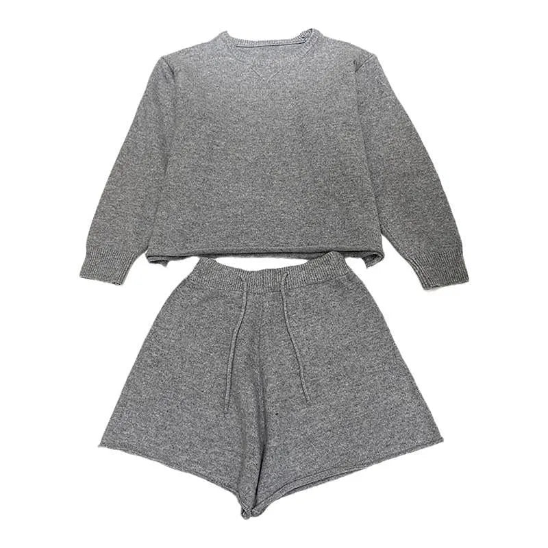Women's knitted two-piece set showing loose-fitting long sleeve sweater and matching wide-leg shorts in neutral colour