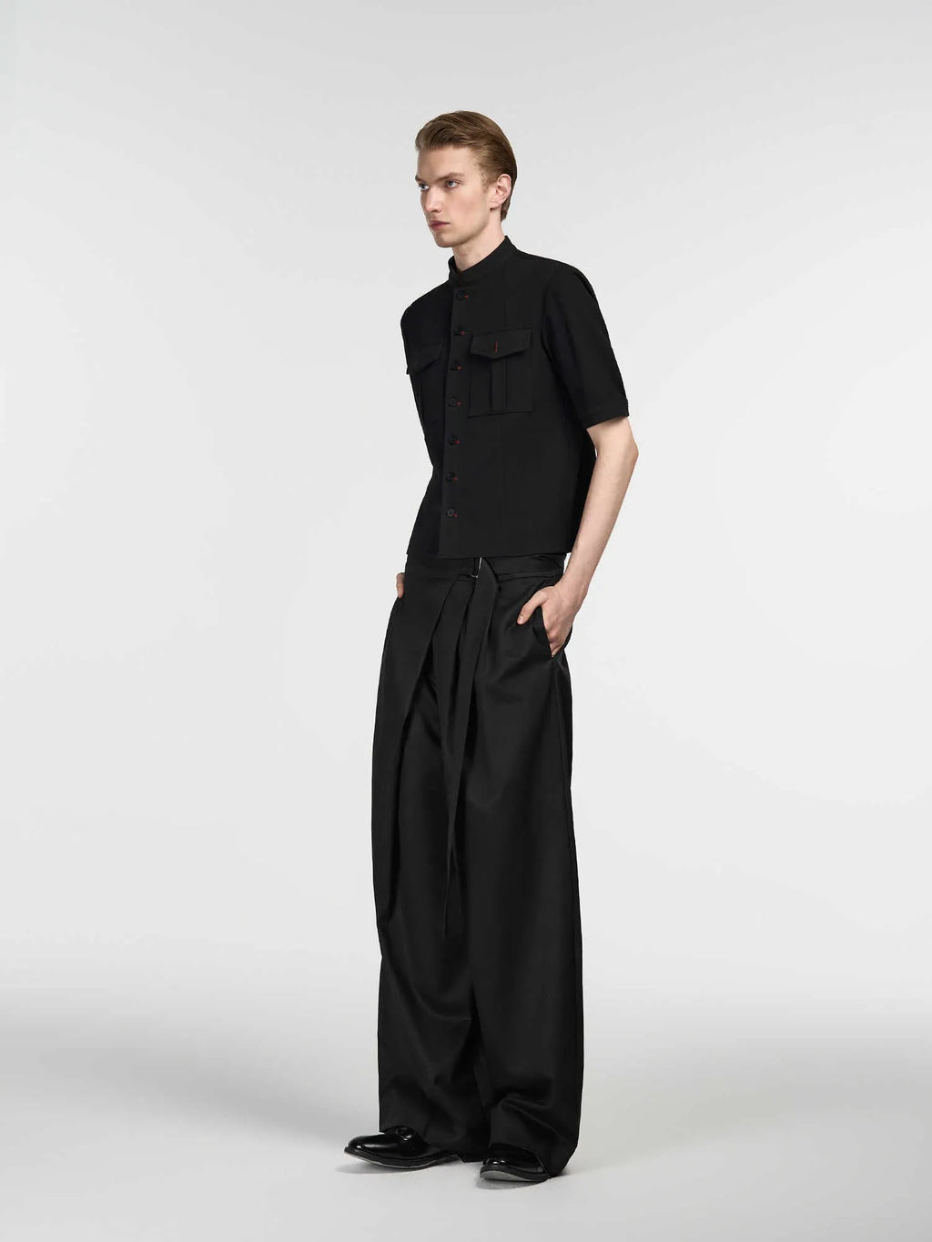 Black straight-leg trousers with adjustable waistband and single pleat detail