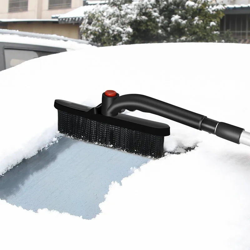Car deicing shovel with black ABS plastic shovel head and brush, telescopic handle extended, on a windscreen with frost