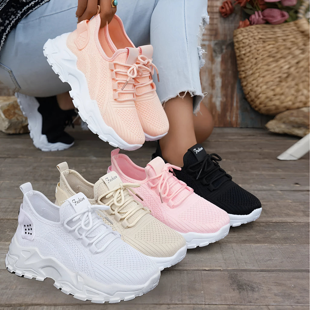 Women's Flyknit mesh casual sports shoes in various colours with flat heel and lace-up front.