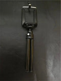 Black aluminium alloy desktop phone holder with an adjustable two-section bracket holding a smartphone.