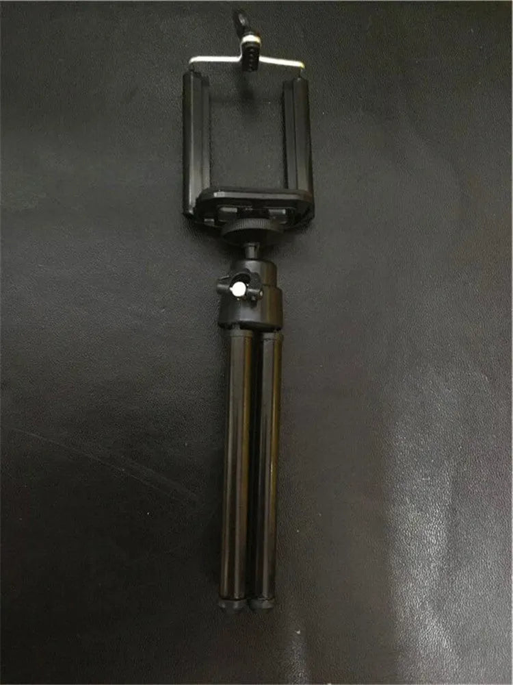 Black aluminium alloy desktop phone holder with an adjustable two-section bracket holding a smartphone.