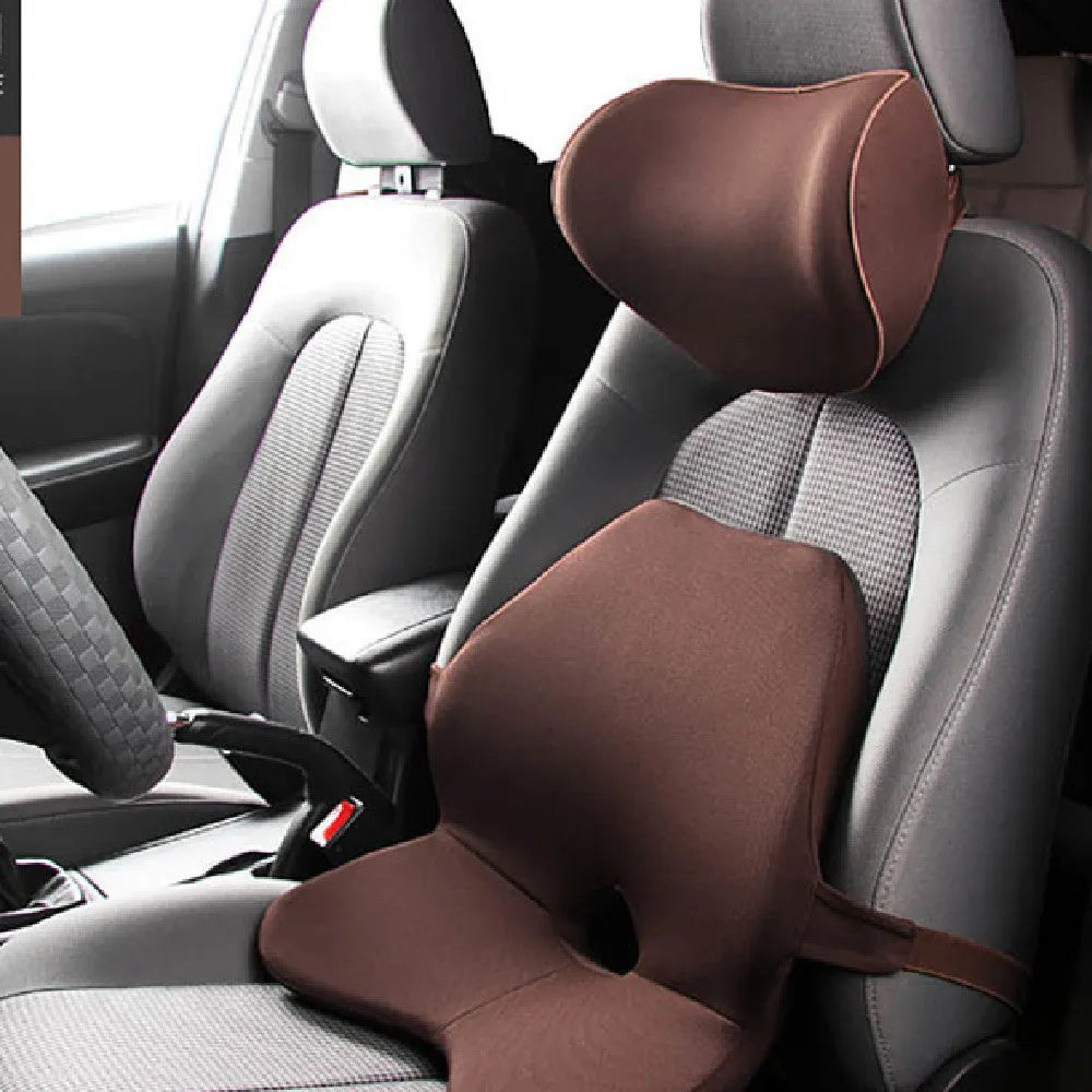 Black memory foam car lumbar support cushion with elastic straps, shown on a grey car seat.