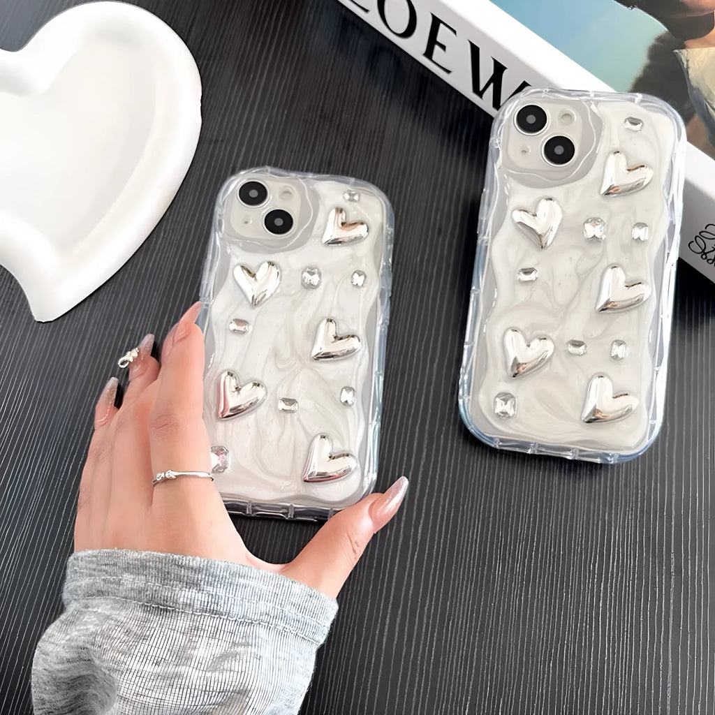 Transparent TPU phone case with three-dimensional silver love gem rhinestone heart design on white background
