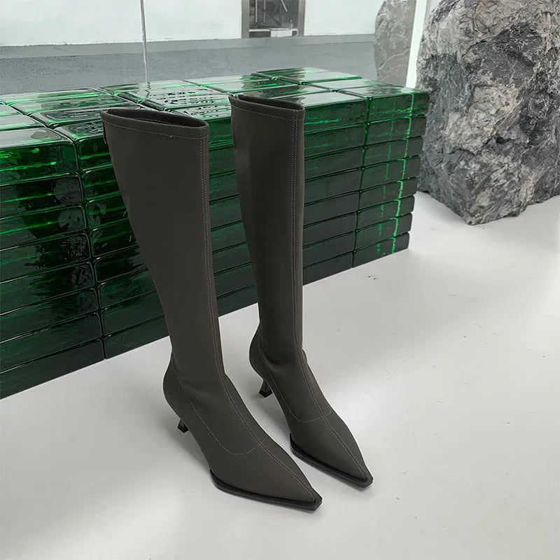Black women's below-the-knee boots with pointed toe, stiletto heel, and a back zipper.