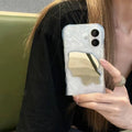 Simple solid colour iPhone case with water ripple texture and a small mirror, shown in beige.