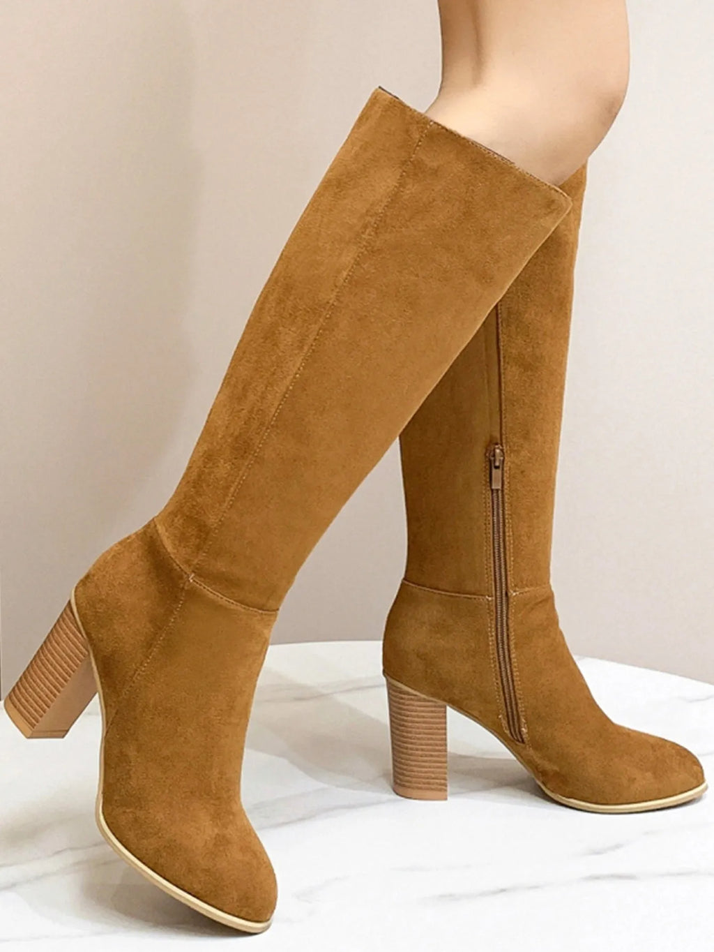 Black women's square toe high heel fashion boots made from artificial PU material.