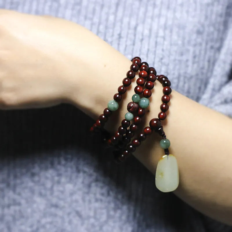 Rosewood bead bracelet with a carved wooden pendant, shown in Indian and Zambia rosewood colour options.