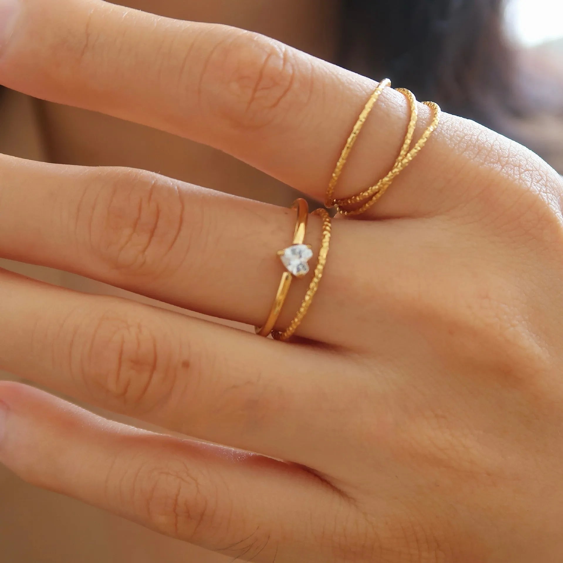Women's golden heart-shaped stainless steel ring with love design in multiple sizes