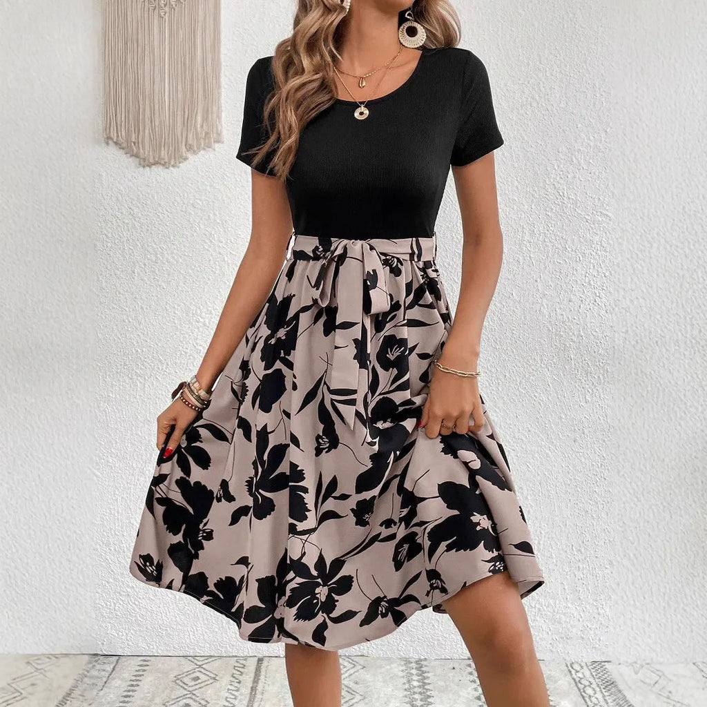 Khaki women's A-line dress with floral plant pattern printing and a shoulder strap detail.