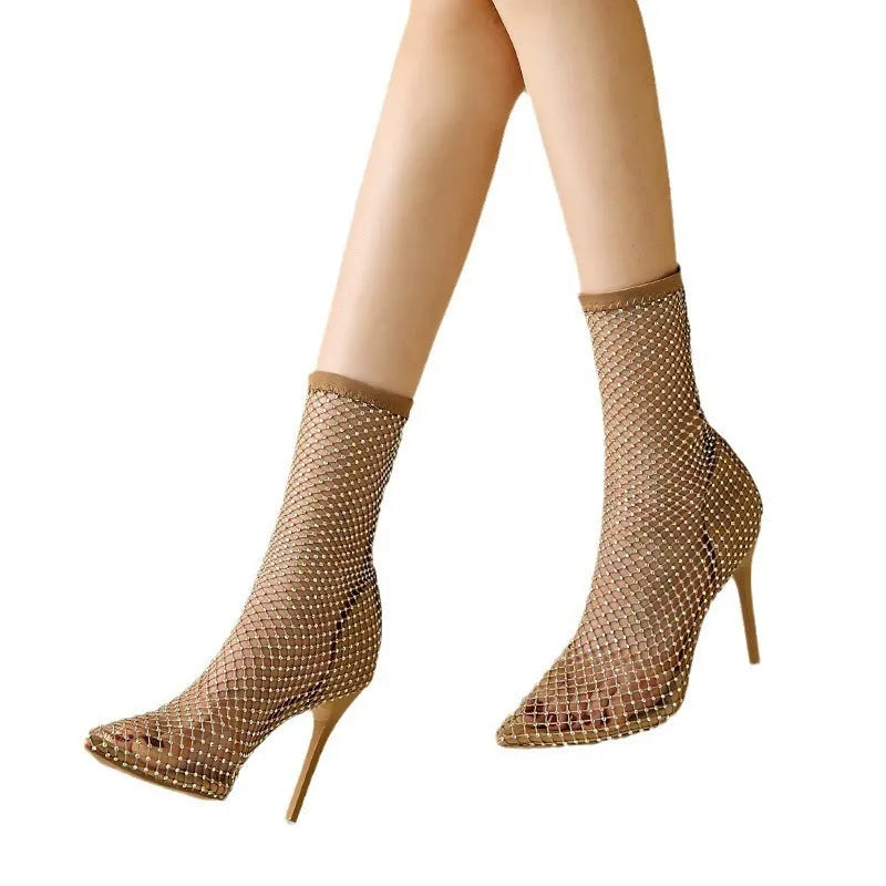 Gold women's high heel sandals with mesh upper, pointed toe, and stiletto heel on a rubber sole.