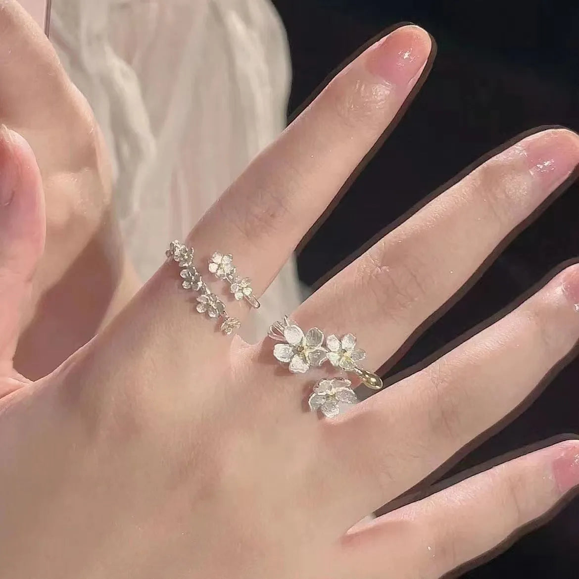 3D jasmine flower adjustable ring in zinc alloy with electroplated finish on a hand.