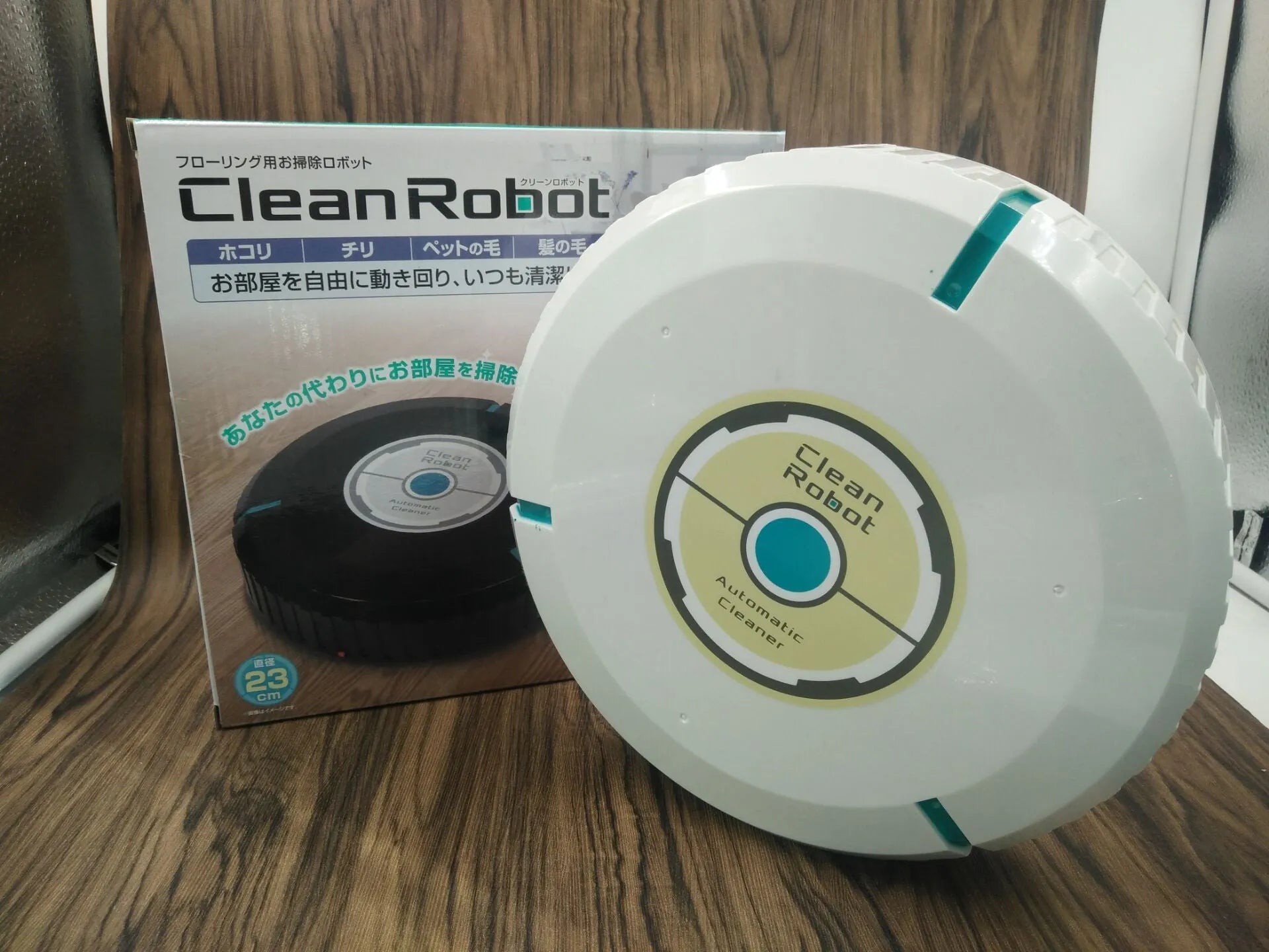 AC robot vacuum cleaner automatic sweeping machine in black or white on a hardwood floor.