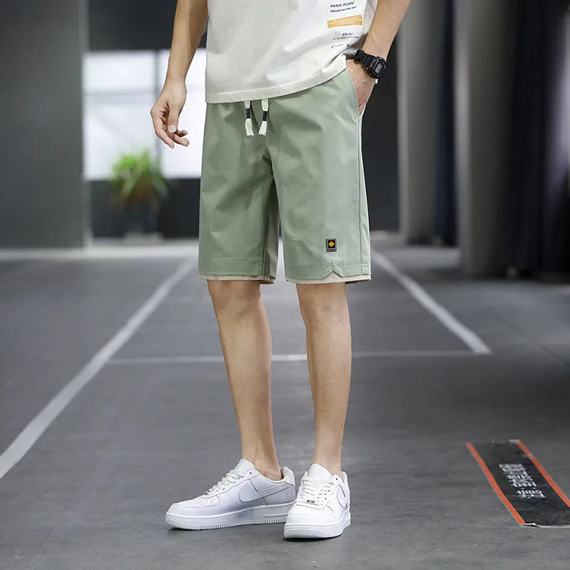 Man's loose-fit casual beach shorts in khaki colour with elasticated waistband.