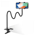 Black metal lazy stand gadget with rotary clip holding mobile phone on bedside table