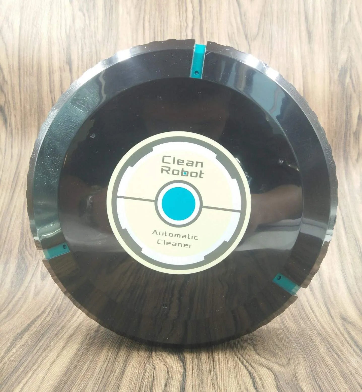 AC robot vacuum cleaner automatic sweeping machine in black or white on a hardwood floor.