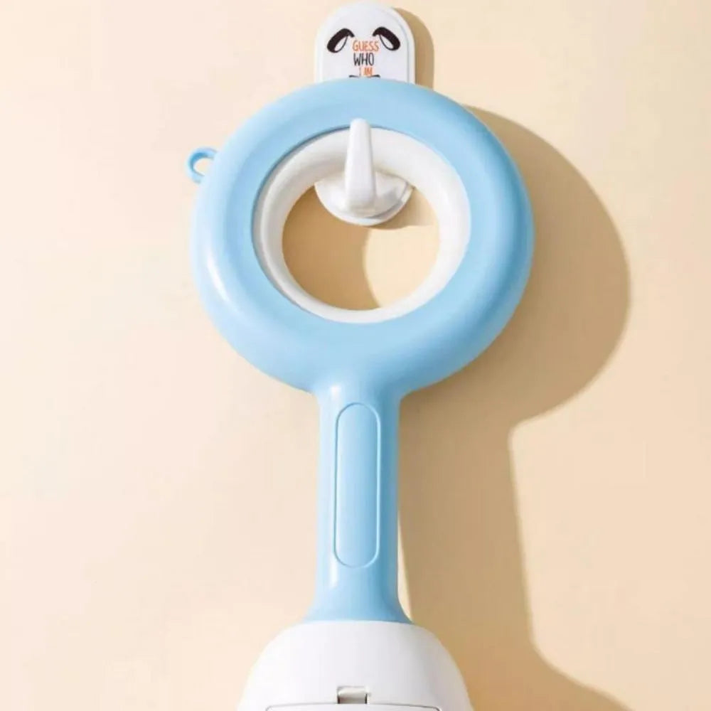 White blue dog pooper scooper with cloud-shaped jaw design on grass