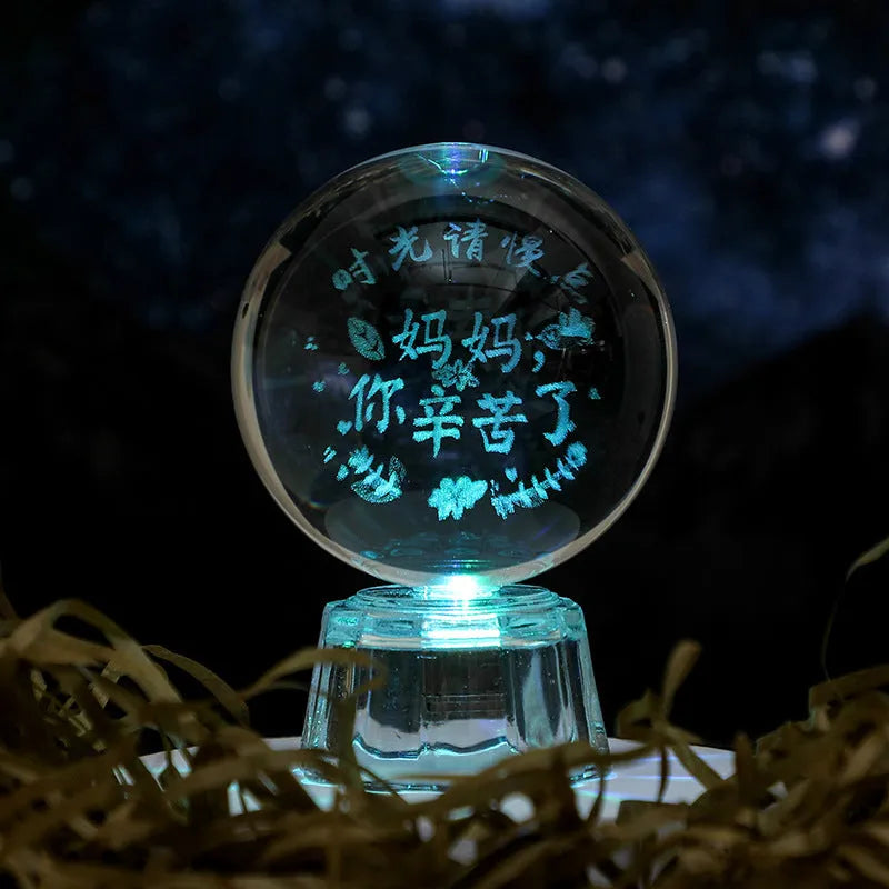 Transparent 6cm white crystal ball ornament with inner carving on a tabletop.